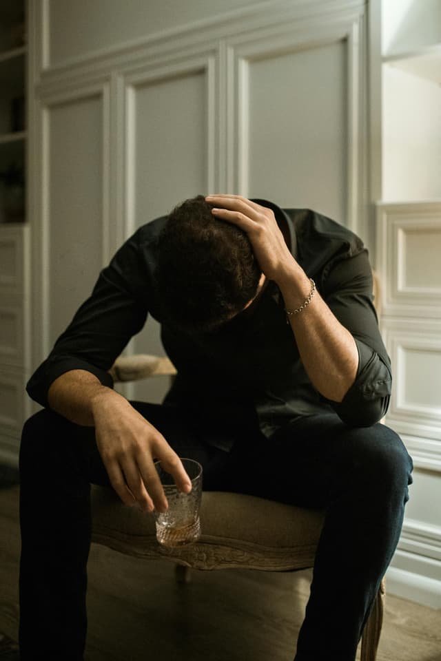 man with his hands in the face crying